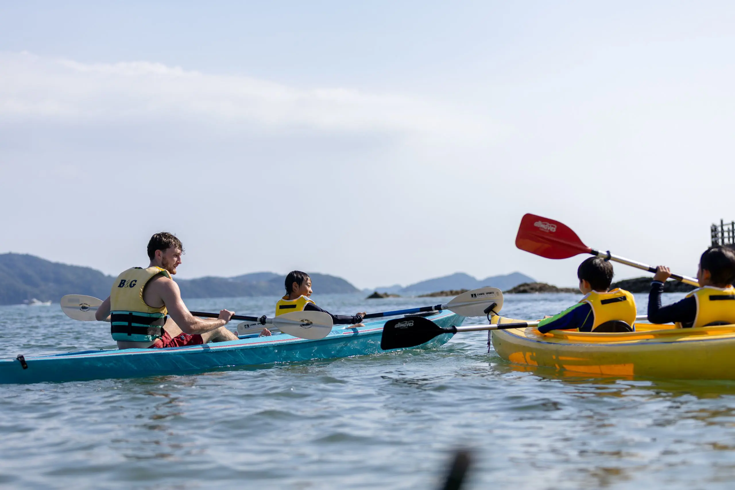 Students and a teacher kayaking whilst learning