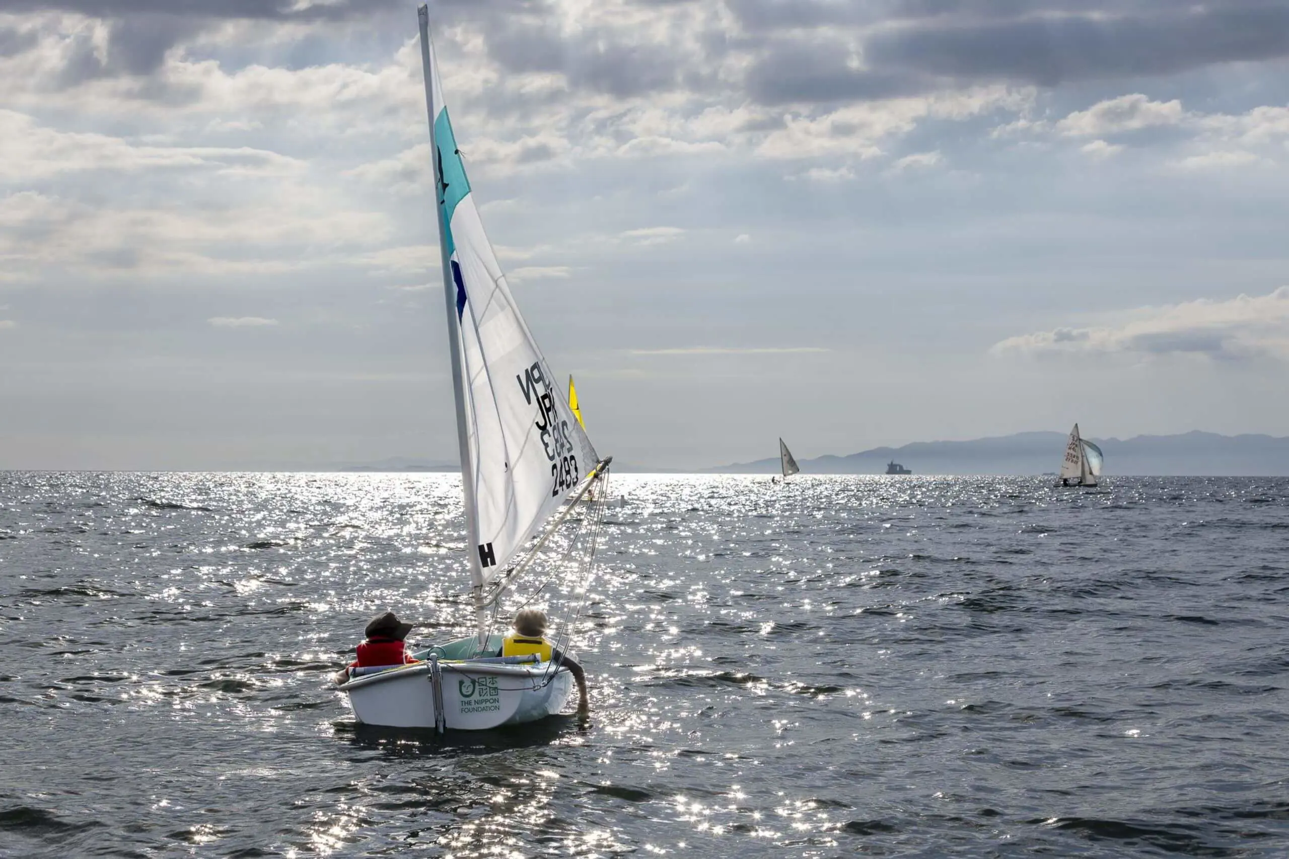 Two students sailing a small boat